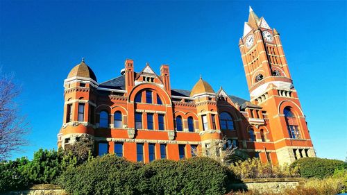 Low angle view of building against blue sky