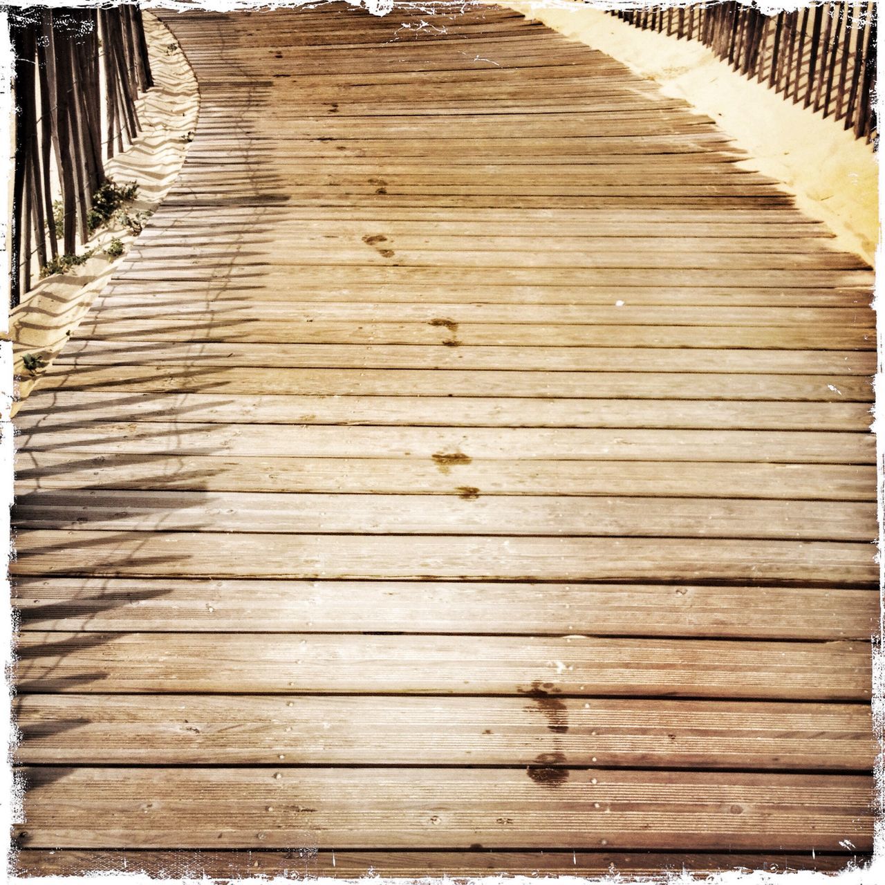 wood - material, wooden, wood, boardwalk, plank, the way forward, wood paneling, diminishing perspective, pattern, high angle view, bench, textured, no people, sunlight, empty, vanishing point, close-up, in a row, day, outdoors