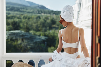 Rear view of woman looking at camera