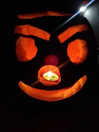 Close-up of illuminated pumpkin against black background