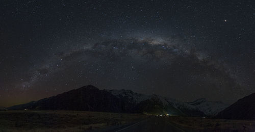 Scenic view of mountains against sky at night