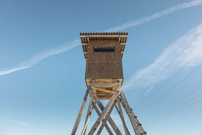 Low angle view of tower against blue sky