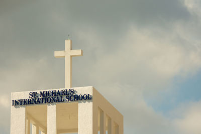 Low angle view of text on building against sky