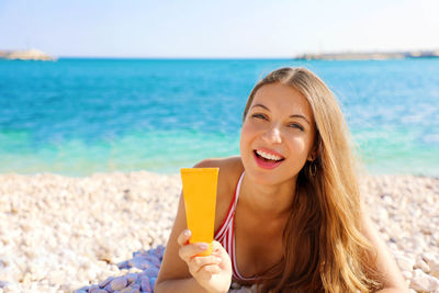 Portrait of a smiling young woman on beach