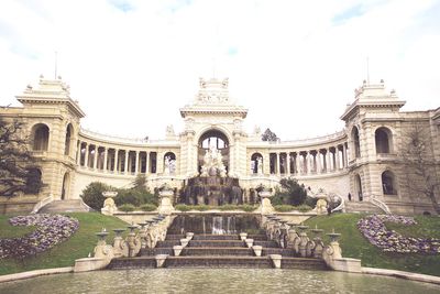 Statue of historic building against cloudy sky