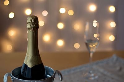 Close-up of wine glass bottle on table