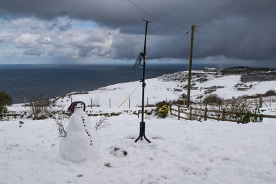 A winter snowy scene with a seaview