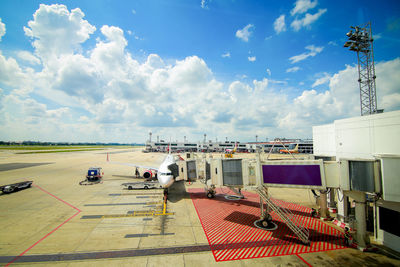 Airplane on runway against sky