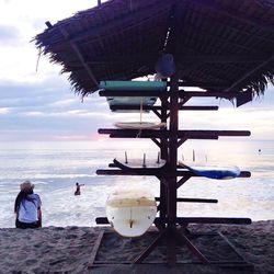 People at beach against sky