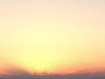 Scenic view of silhouette mountain against orange sky