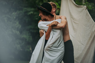 Rear view of couple holding hands