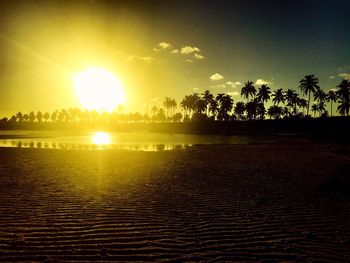 Scenic view of beach against sky during sunset