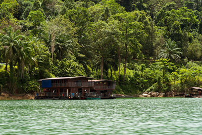 Built structure in water against trees