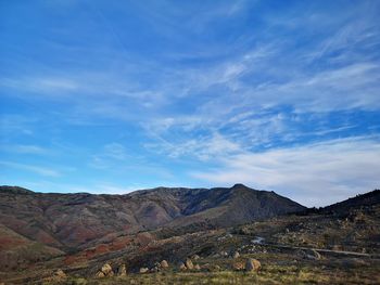 Scenic view of mountains against blue sky