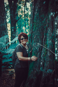 Portrait of smiling young woman in forest