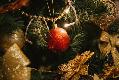 Close-up of christmas decorations hanging on tree