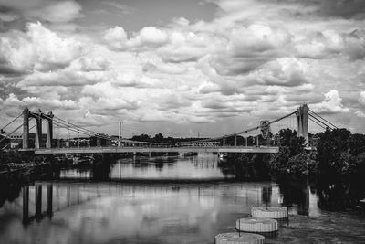 Hennepin avenue bridge over river against cloudy sky