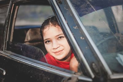 Portrait of boy smiling in car