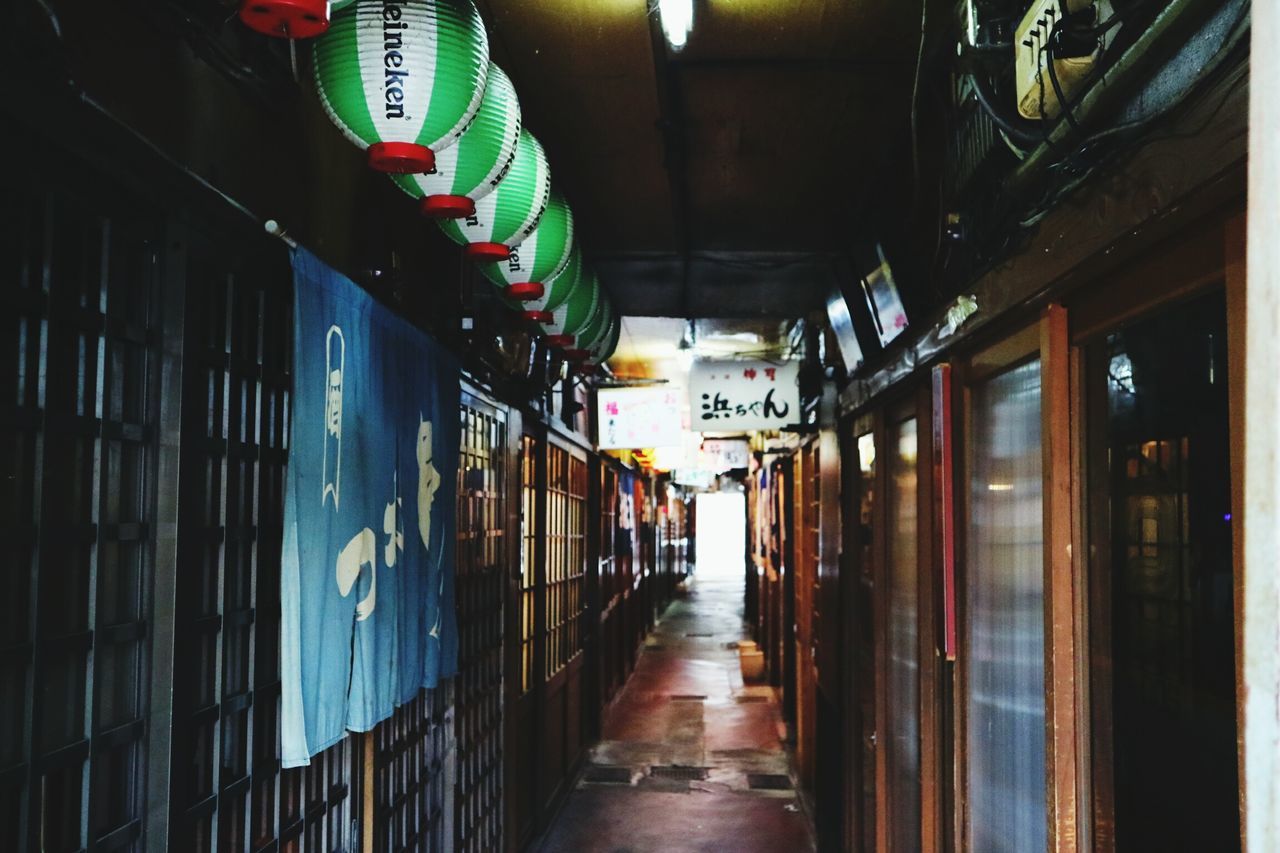 architecture, illuminated, built structure, the way forward, diminishing perspective, lighting equipment, night, building, narrow, corridor, alley, store, vanishing point, city, city life, empty, no people, architectural column, walkway