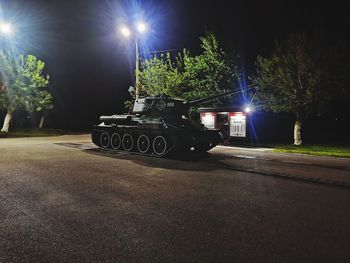 Illuminated street light on road at night