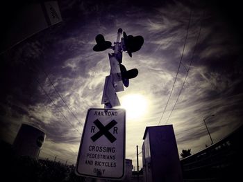 Low angle view of street light against cloudy sky