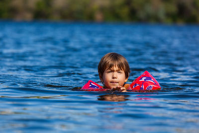 Boy swimming in lake