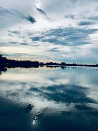 Scenic view of lake against sky at dusk