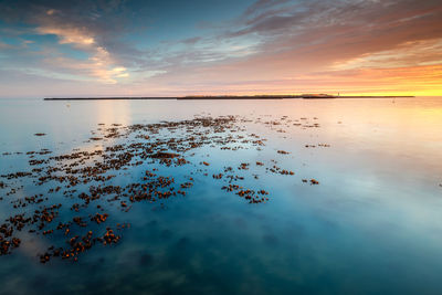 Scenic view of sea against sky at sunset