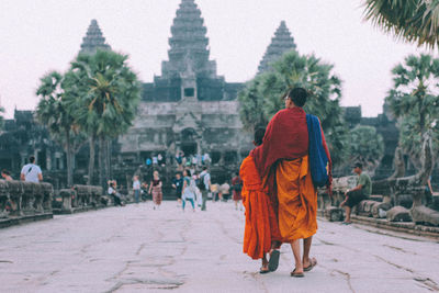 Rear view of people walking outdoors