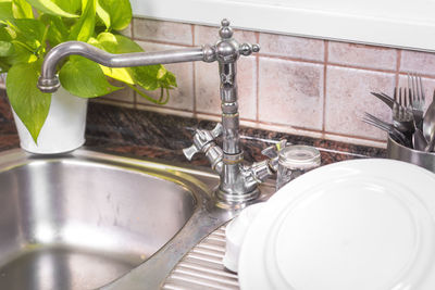 Close-up of faucet in bathroom at home