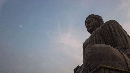 Low angle view of statue against sky