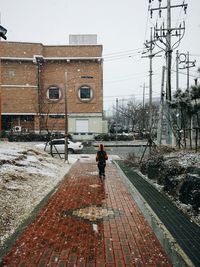 Full length of woman walking in city