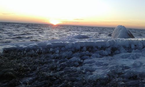 Scenic view of sea against clear sky during sunset