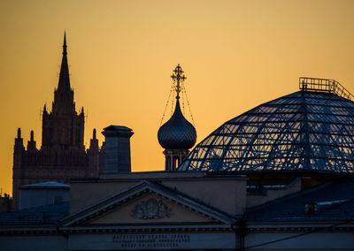 Low angle view of built structure against sky at sunset