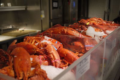 Lobsters in containers at commercial kitchen