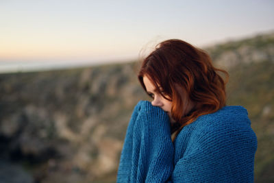 Rear view of woman at beach during sunset