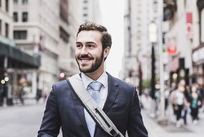 Young man standing in city