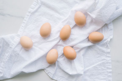 Brown eggs on a white kitchen towel