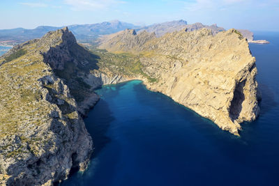 High angle view of rocks by sea against sky