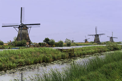 Traditional windmill on field against sky