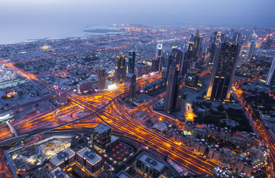 Aerial view of city lit up at night