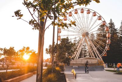 View of ferris wheel against sky during sunset