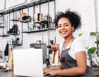 Portrait of young woman standing in factory