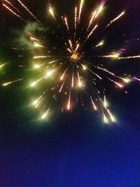 Low angle view of firework display at night