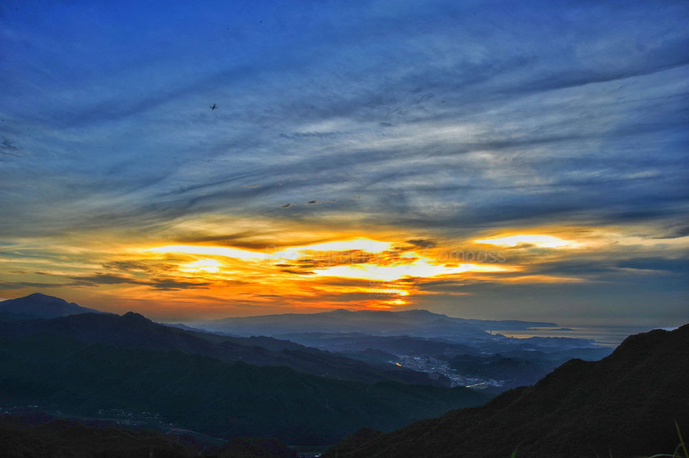 SCENIC VIEW OF MOUNTAINS AT SUNSET