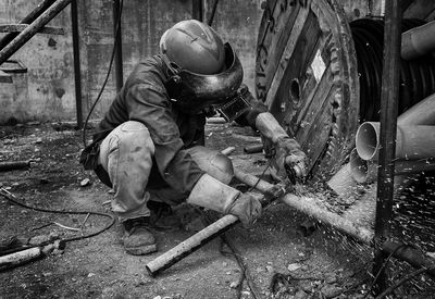 Manual worker welding metal at workshop