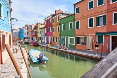 Boats in canal in city