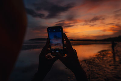 Low section of woman using mobile phone