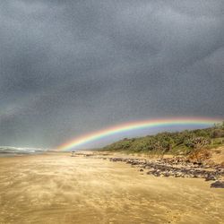 Scenic view of rainbow over landscape