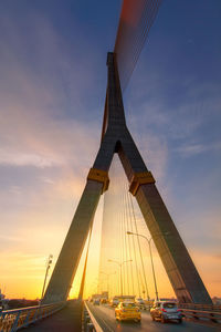 Low angle view of suspension bridge against sky during sunset